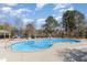 Large community pool with lounge chairs and shade, perfect for relaxation and outdoor fun on sunny days at 4320 Stony Falls Way, Knightdale, NC 27545