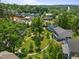 A beautiful aerial shot showcasing lush greenery, neighborhood residences, and mature trees, creating a serene community setting at 445 S Greensboro St, Carrboro, NC 27510