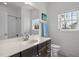 Well-lit bathroom featuring a spacious vanity and shower-tub combination at 445 S Greensboro St, Carrboro, NC 27510