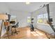 Large, light-filled home office with hardwood flooring and multiple windows at 445 S Greensboro St, Carrboro, NC 27510