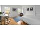 Sunlit bedroom with a comfortable chair, desk, and a large window with outdoor views at 445 S Greensboro St, Carrboro, NC 27510