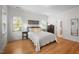 Bright bedroom featuring large windows, neutral decor, and hardwood floors at 445 S Greensboro St, Carrboro, NC 27510