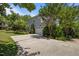 Traditional two-story home with a two-car garage, a large driveway, and mature trees at 445 S Greensboro St, Carrboro, NC 27510