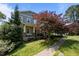 Charming two-story home with a covered front porch, a porch swing, and a landscaped yard at 445 S Greensboro St, Carrboro, NC 27510