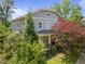 Charming two-story home with a covered front porch and mature landscaping creates great curb appeal at 445 S Greensboro St, Carrboro, NC 27510