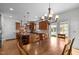 Modern kitchen with wooden cabinets, stainless steel appliances, granite countertops and large island with seating at 445 S Greensboro St, Carrboro, NC 27510