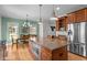Open kitchen with granite island, stainless steel appliances, and adjacent dining area at 445 S Greensboro St, Carrboro, NC 27510