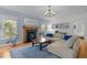 Cozy living room with fireplace, hardwood floors, and large windows offers a comfortable gathering space at 445 S Greensboro St, Carrboro, NC 27510