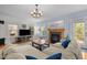 Spacious living room boasts natural light, a fireplace, and comfortable sectional sofa at 445 S Greensboro St, Carrboro, NC 27510