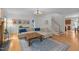 Bright living room with a cozy sectional sofa, wood floors, a decorative rug, and a fireplace at 445 S Greensboro St, Carrboro, NC 27510