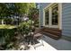 Charming patio with outdoor seating and dining area, surrounded by lush greenery, ideal for relaxation at 445 S Greensboro St, Carrboro, NC 27510
