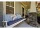 Inviting front porch with a comfortable porch swing and stone-wrapped support columns at 445 S Greensboro St, Carrboro, NC 27510