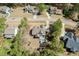 An aerial view of a beautiful home with an in-ground swimming pool surrounded by lush greenery and mature trees at 45 Carriden Dr, Youngsville, NC 27596