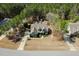 An aerial view of a beautiful house surrounded by lush greenery and mature trees with a gray roof at 45 Carriden Dr, Youngsville, NC 27596