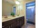 Bathroom with a double vanity, large mirror, and shower-tub combination at 45 Carriden Dr, Youngsville, NC 27596