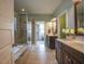 Elegant bathroom boasts a glass-enclosed shower, a soaking tub, and dual sink vanity with modern fixtures at 45 Carriden Dr, Youngsville, NC 27596