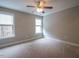 Bedroom with two windows, carpeted flooring, and a ceiling fan at 45 Carriden Dr, Youngsville, NC 27596