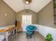 Finished interior of shed with chair, table, finished wood flooring and ceiling with painted walls at 45 Carriden Dr, Youngsville, NC 27596