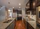 Modern kitchen featuring granite counters, stainless appliances, a gas cooktop, and center island seating at 45 Carriden Dr, Youngsville, NC 27596