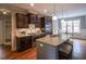 Gourmet kitchen with granite countertops, stainless steel appliances, dark wood cabinets, and a kitchen island at 45 Carriden Dr, Youngsville, NC 27596