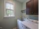 Convenient laundry room featuring a window, washer, and dryer for easy chore completion at 45 Carriden Dr, Youngsville, NC 27596