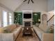 Bright living room with vaulted ceilings, fireplace, custom built-ins, and access to the backyard at 45 Carriden Dr, Youngsville, NC 27596