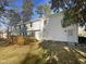 The backyard features a raised wood deck, white siding and a grassy yard at 4601 Pemberton Dr, Raleigh, NC 27609