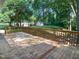 Wood deck overlooking a lush backyard, surrounded by trees and greenery, with a small shed in the distance at 4601 Pemberton Dr, Raleigh, NC 27609
