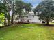 Spacious backyard features a wooden deck, a well-maintained lawn, and mature trees for added privacy at 4601 Pemberton Dr, Raleigh, NC 27609