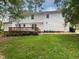 Spacious backyard with a large deck, lush green lawn, and privacy from surrounding trees at 4601 Pemberton Dr, Raleigh, NC 27609