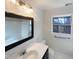This bathroom has a vanity sink with mirror and updated fixtures, plus natural light at 4601 Pemberton Dr, Raleigh, NC 27609