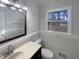 Updated bathroom with bright light, clean lines, vanity and a large mirror at 4601 Pemberton Dr, Raleigh, NC 27609