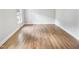 Bright empty bedroom with hardwood floors, neutral walls, a window, and ample space for furniture at 4601 Pemberton Dr, Raleigh, NC 27609