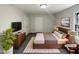 This staged bedroom features modern furniture, decor and a large screen television at 4601 Pemberton Dr, Raleigh, NC 27609
