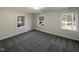 This cozy bedroom is carpeted and has three windows, allowing for ample natural light at 4601 Pemberton Dr, Raleigh, NC 27609