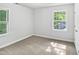 Bright, neutrally painted bedroom with ample natural light and neutral carpet at 4601 Pemberton Dr, Raleigh, NC 27609