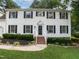 Classic two-story home with tidy landscaping, black shutters, and a welcoming front entrance at 4601 Pemberton Dr, Raleigh, NC 27609