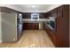 Well lit eat-in kitchen with stainless steel appliances, wood cabinets and wood flooring at 4601 Pemberton Dr, Raleigh, NC 27609
