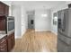 Bright kitchen with stainless steel appliances, light-colored walls, wood floors, and a connecting dining area at 4601 Pemberton Dr, Raleigh, NC 27609