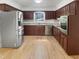 Spacious kitchen with stainless steel appliances, granite countertops, and light hardwood floors at 4601 Pemberton Dr, Raleigh, NC 27609