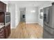Bright kitchen with stainless steel appliances, light-colored walls, wood floors, and a connecting dining area at 4601 Pemberton Dr, Raleigh, NC 27609
