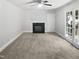Bright living room with fireplace, ceiling fan, French doors, and neutral tones at 4601 Pemberton Dr, Raleigh, NC 27609
