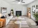 Bright living room with fireplace, ceiling fan, French doors, and neutral tones at 4601 Pemberton Dr, Raleigh, NC 27609