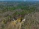 Aerial image of the home and metal outbuilding nestled in the woods at 471 Deer Run, Pittsboro, NC 27312