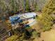 Aerial view showcases a charming home with deck and porch in a private, wooded setting at 471 Deer Run, Pittsboro, NC 27312