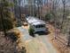 Quaint home featuring a screened porch and wooden deck, nestled among mature trees at 471 Deer Run, Pittsboro, NC 27312