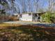 Spacious single story home with a large yard, a deck, and well-maintained landscaping at 471 Deer Run, Pittsboro, NC 27312