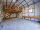Interior view of garage with stairs to a loft area, workbench, and exposed frame construction at 471 Deer Run, Pittsboro, NC 27312