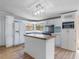 Well-lit kitchen featuring white cabinetry, a center island, and stainless steel appliances at 471 Deer Run, Pittsboro, NC 27312