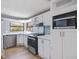 Bright kitchen with stainless steel appliances, white cabinetry, and hardwood floors at 471 Deer Run, Pittsboro, NC 27312